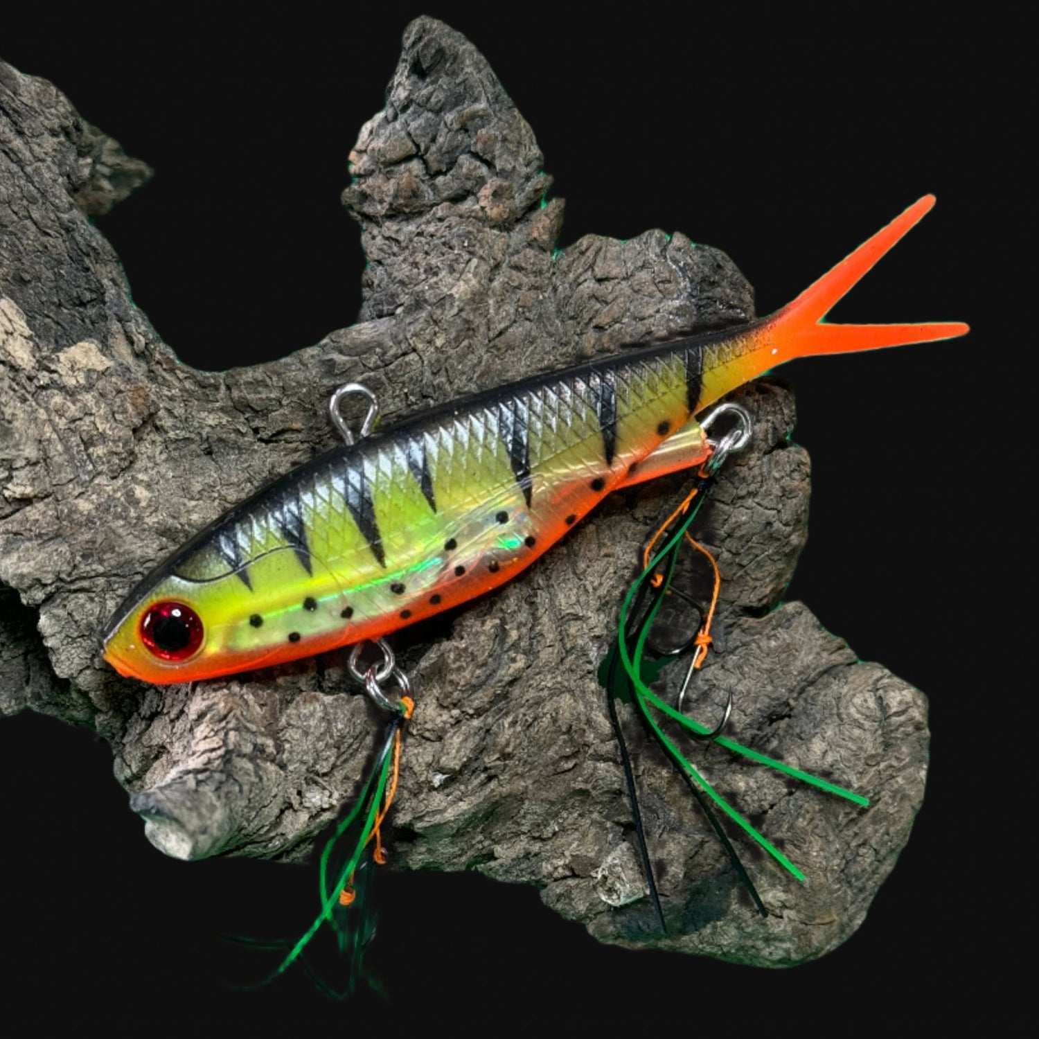 A multicoloured fishing lure with a vibrating tail designed to imitate the movement of fish, equipped with two sets of BKK stinger hooks.