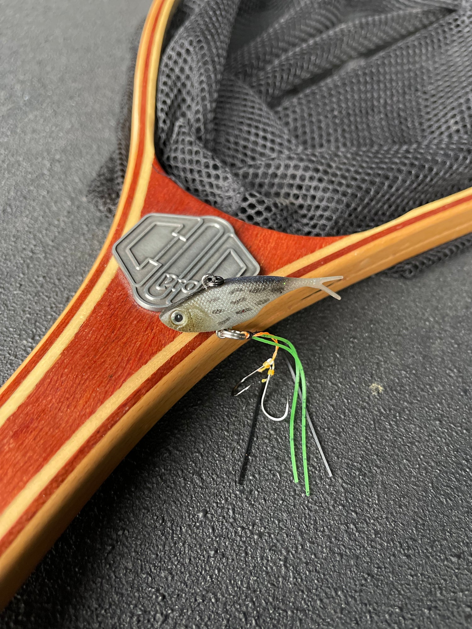 A grey with stripes coloured fishing lure named 'Shammy Vibes' soft vibe 55mm yellow belly assist hooks