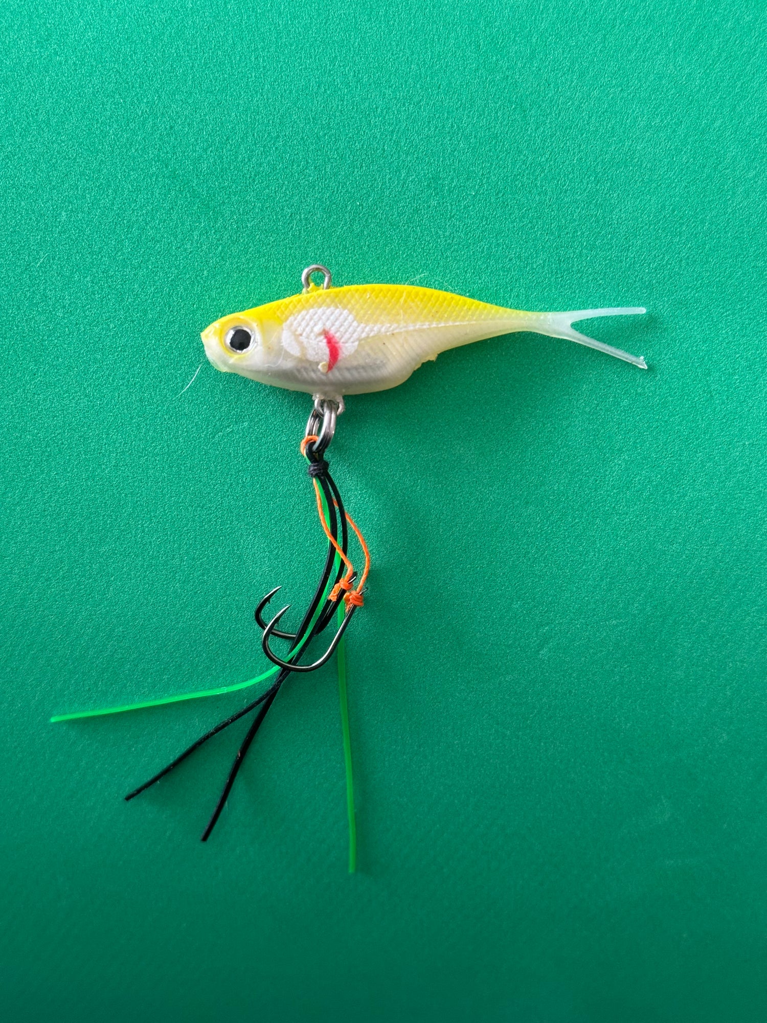 A yellow and white coloured fishing lure named 'Shammy Vibes' soft vibe 55mm yellow belly assist hooks