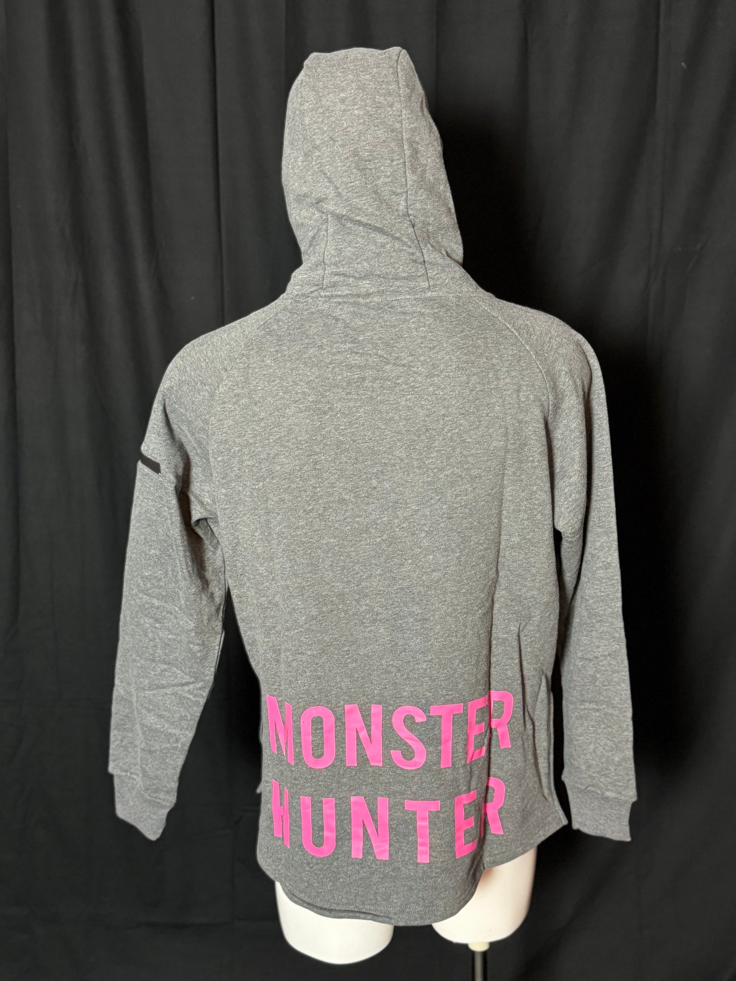 A grey hoodie with the text 'COD PRO SHOP' displayed prominently, featuring a hood and a built-in neck scarf. The hoodie is presented on a mannequin against a black background.
