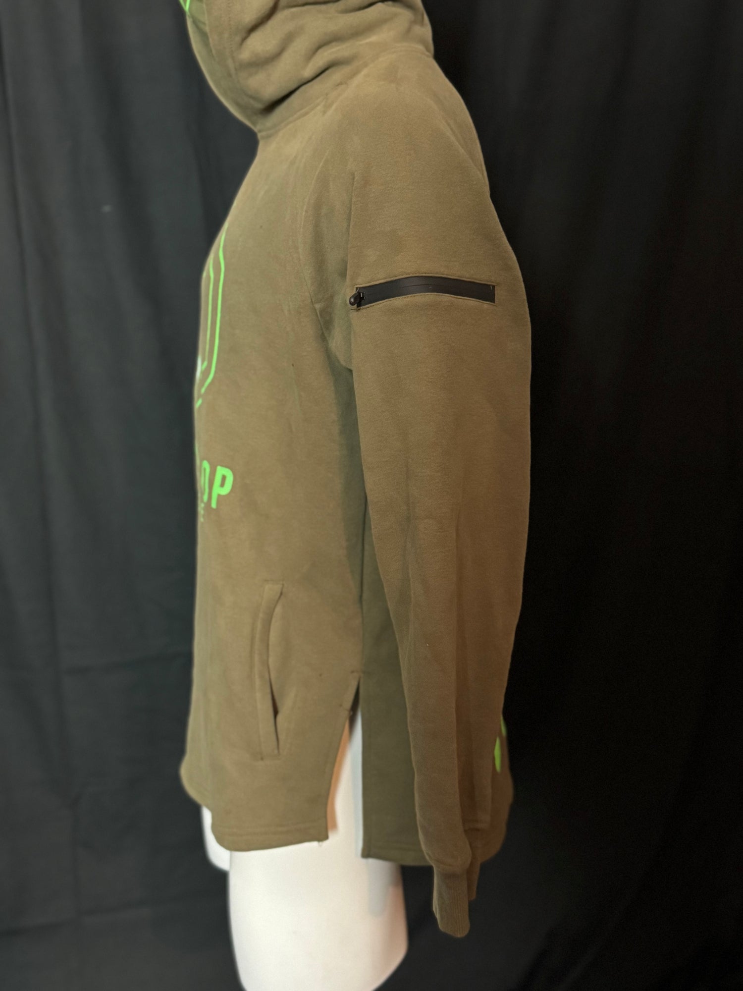 A green hoodie with the text 'COD PRO SHOP' displayed prominently, featuring a hood and a built-in neck scarf. The hoodie is presented on a mannequin against a black background.