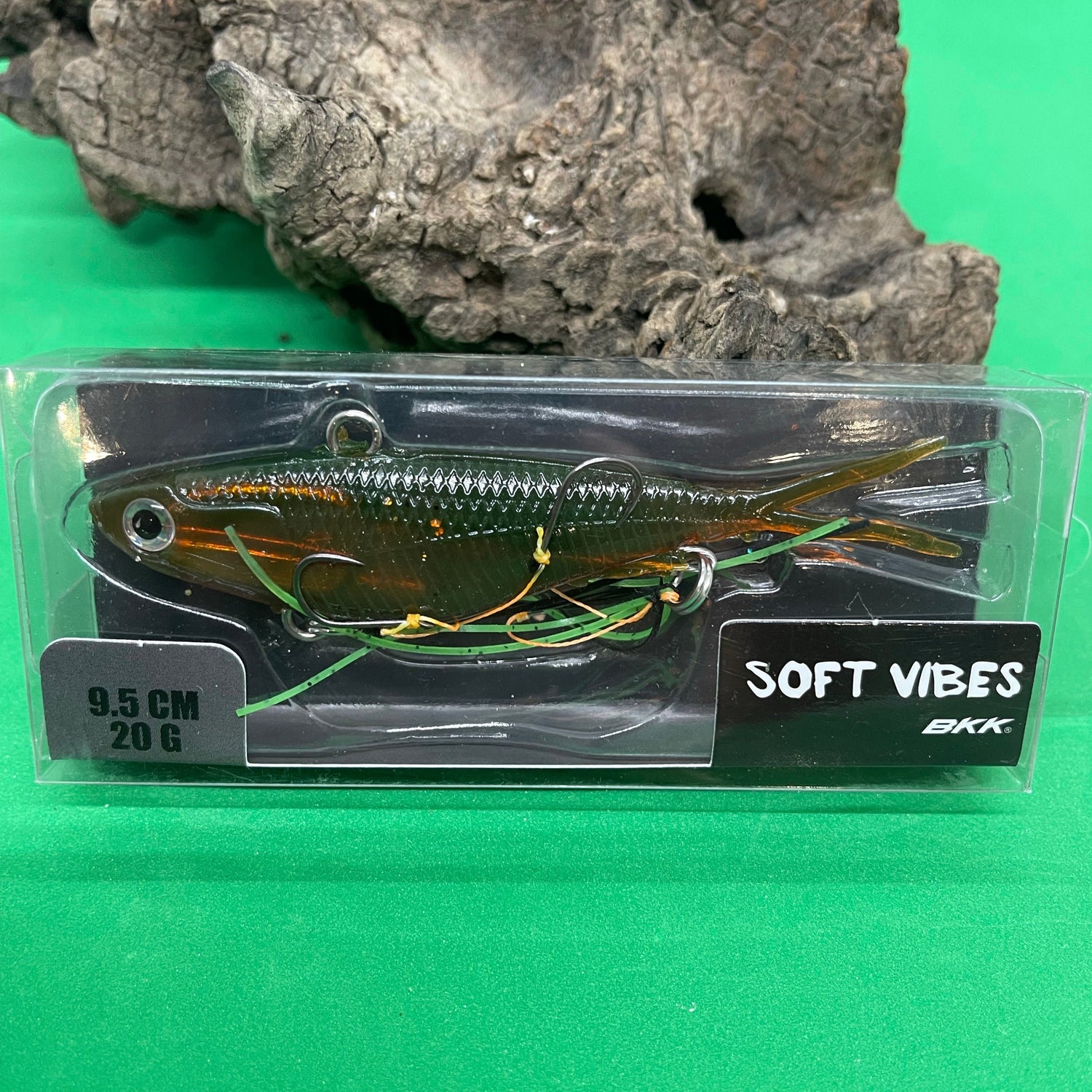 A packaged fishing lure named Shammy Vibes 95mm, predominantly red and white in color, displayed in front of a natural background.