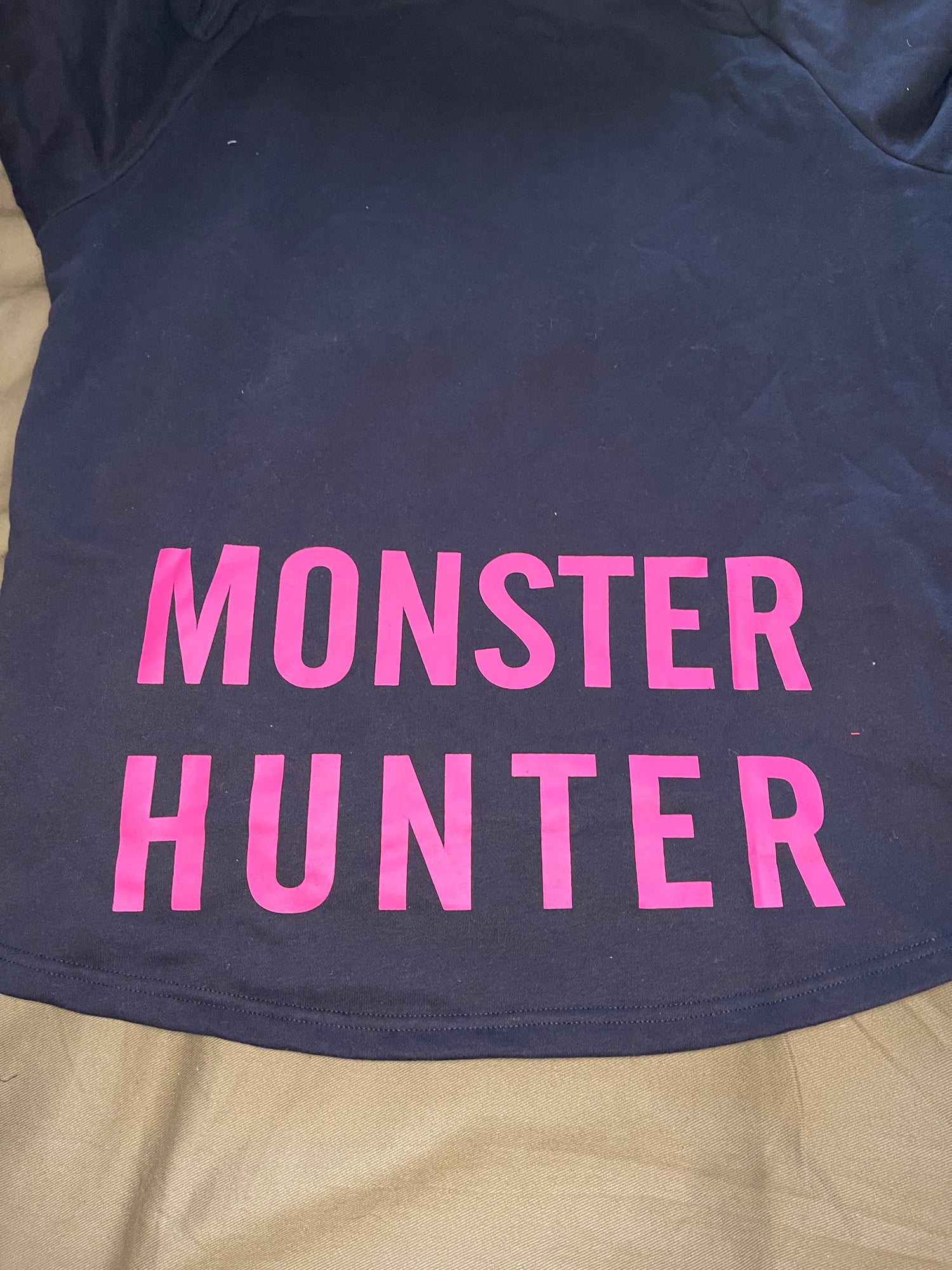 A black hoodie with the text 'COD PRO SHOP' displayed prominently, featuring a hood and a built-in neck scarf. The hoodie is presented on a mannequin against a black background.