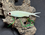 A multicoloured fishing lure with a vibrating tail designed to imitate the movement of fish, equipped with two sets of stinger hooks.