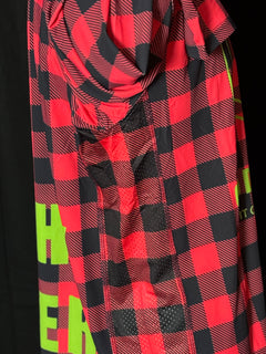 A person wearing a red and black checkered fishing shirt with a hood, featuring a graphic logo, cod pro shop