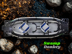 Top-down view of a Swamp Donkey boat on a natural setting with rocks and plants.