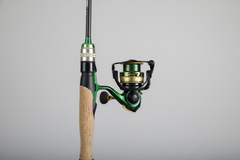 Fishing rod and reel with green accents by cod pro shop